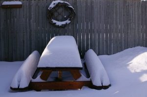 Picnic table covered with snow