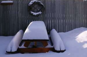 Picnic table covered with snow